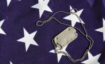 Military necklace on top of stars on the American flag.