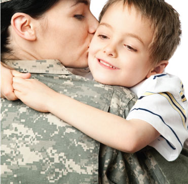 Female veteran kissing child.