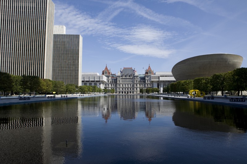 View of pond, sky, and buildings in Albany, NY.