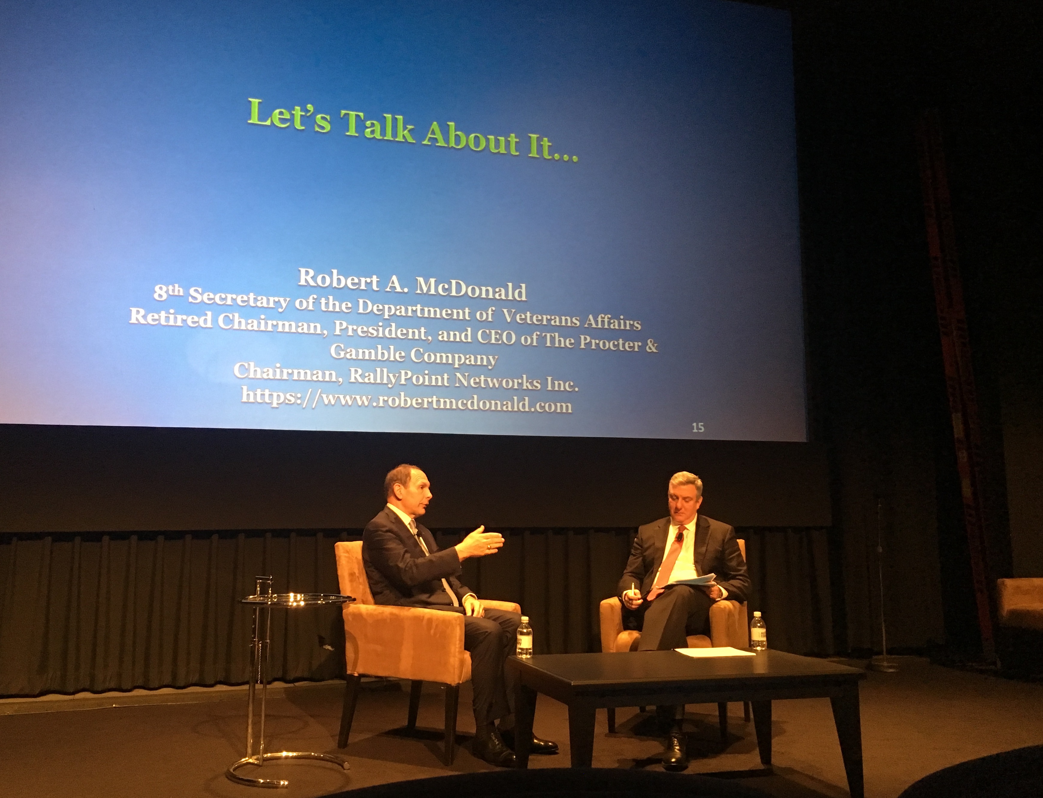 David Sandman, President and CEO of NYHealth, on stage with Robert A. McDonald, former Secretary of the Department of Veterans Affairs, at an NYHealth conference.