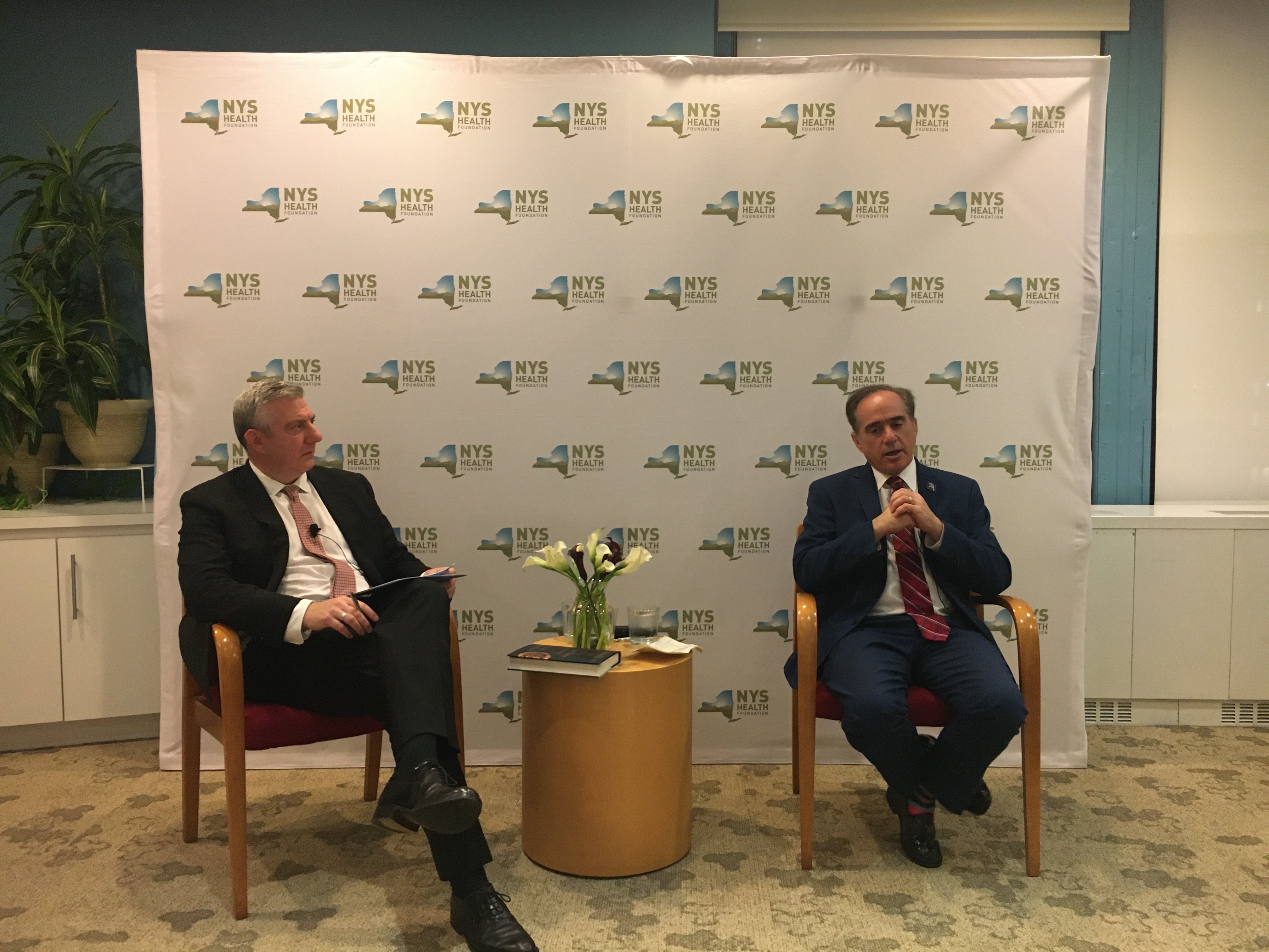 NYHealth President and CEO David Sandman sits with guest speaker David Shulkin, former VA Secretary, at an NYHealth event.