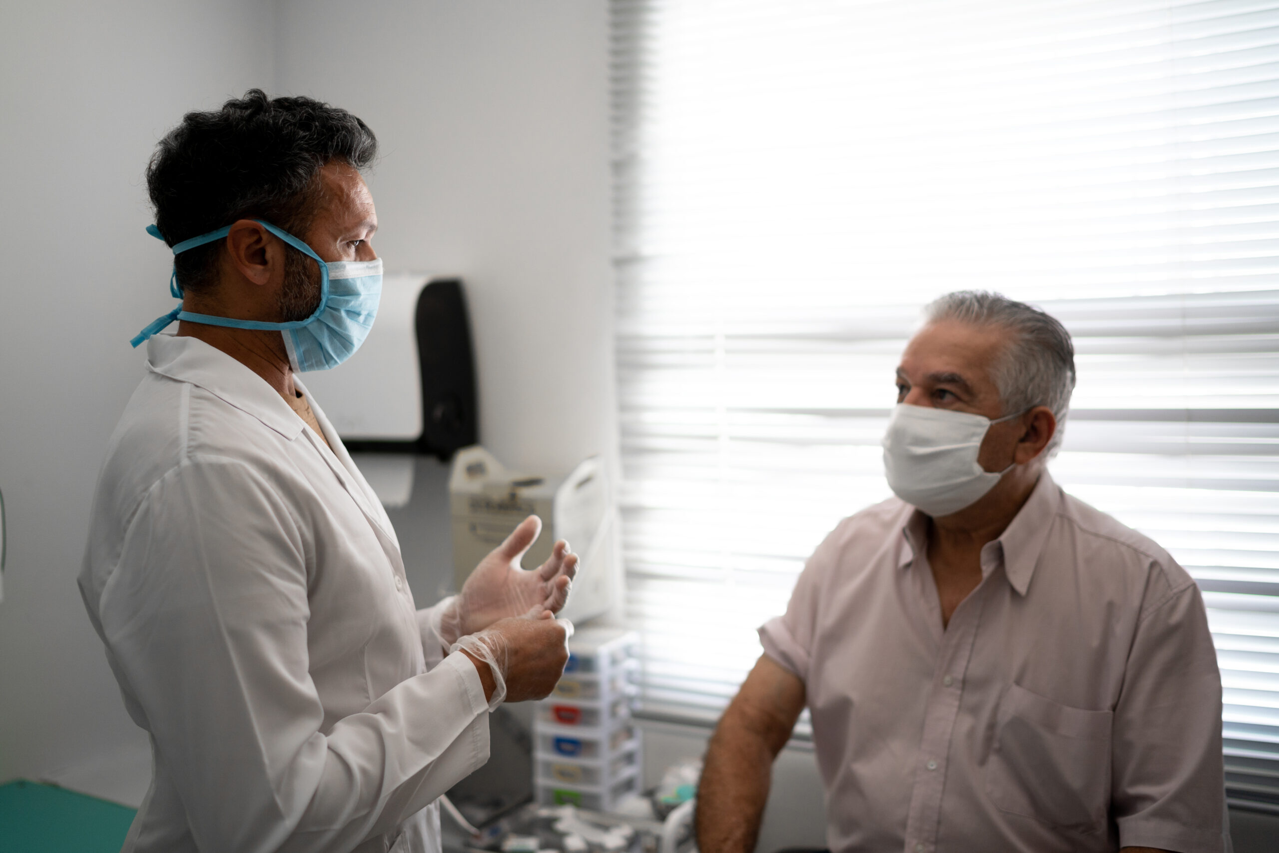 Patient and doctor wearing face masks during appointment.