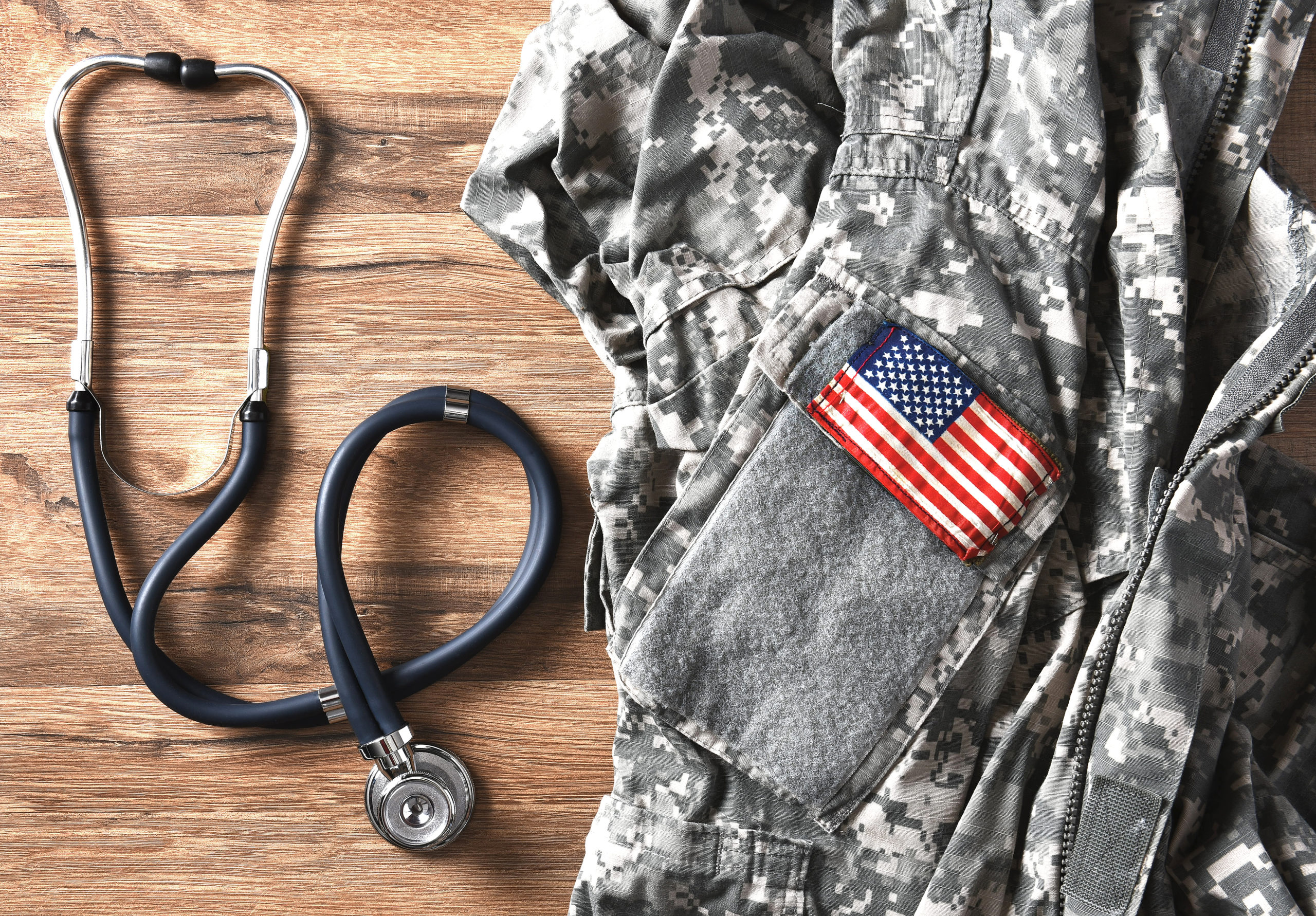 Military fatigues and stethoscope on a table.