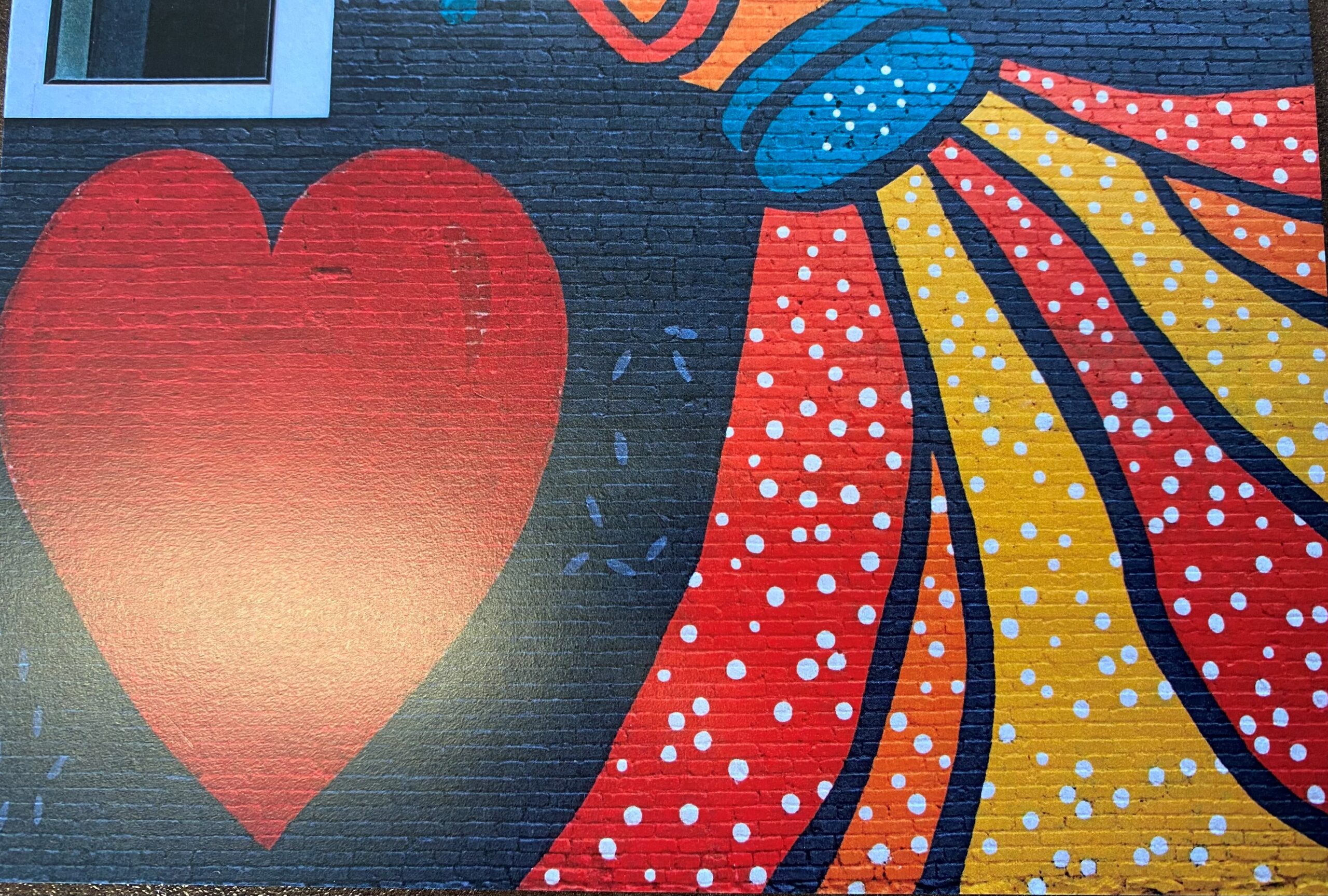 A mural with a red heart and a salt shaker titled "Everything but the Kitchen" in Syracuse, NY.